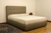 Gray leather double bed with modern stitched-square headboard