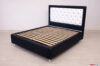 Modern custom bed with contrasting stitching and high feet