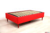 Red single bed with high feet