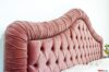 Upholstered headboard with pleated and capitonné roll in pink velvet