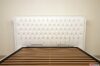 Large white capitonné headboard bed