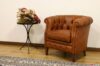 Brown leather hotel room armchair