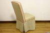 Upholstered chair with beige fabric skirt