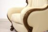 Handcrafted leather and solid wood armrest detail